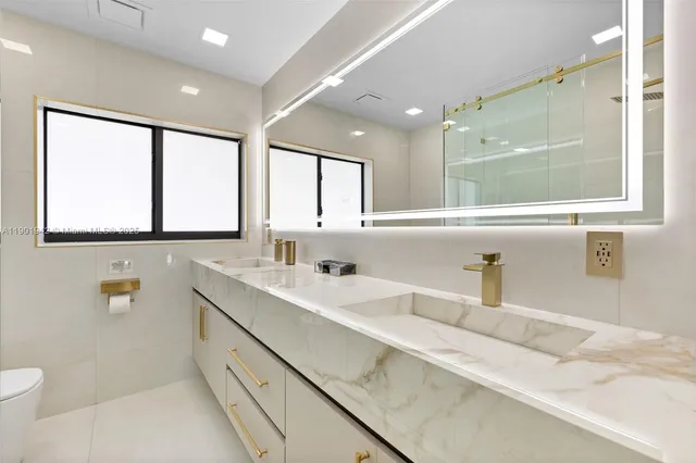 a bathroom with a shower and a sink