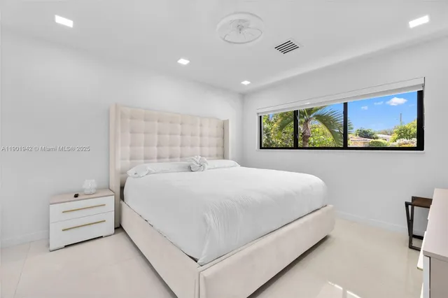 a large white bed in a white room