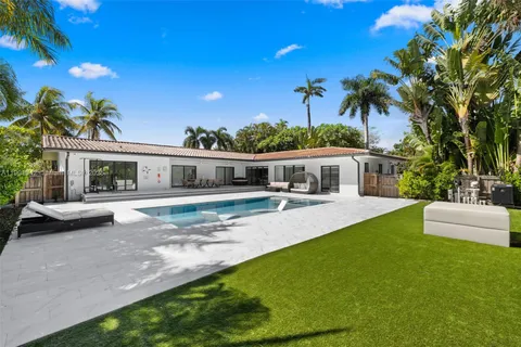 a view of a swimming pool with an outdoor space and seating area