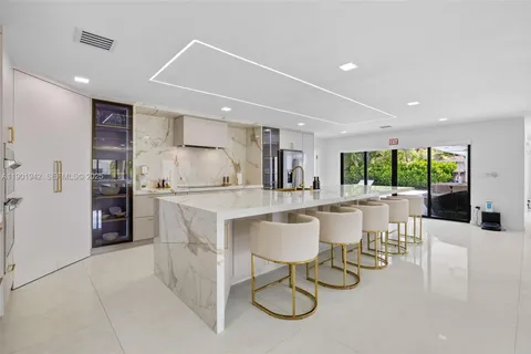 a kitchen with a table and chairs