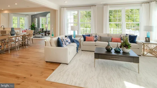 a living room with furniture and large windows