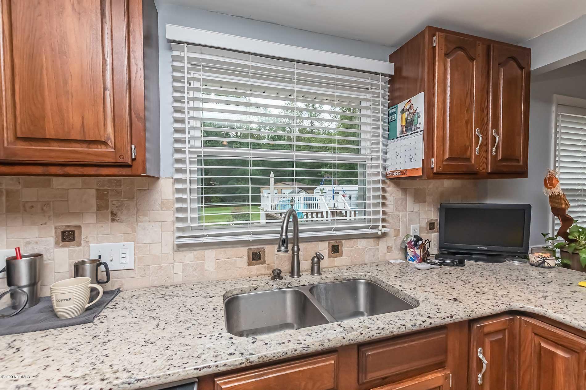 289 Lester Watts Road Tabor City, NC 28463 - Photo 9 of 29 Kitchen sink with window view of beautiful backyard