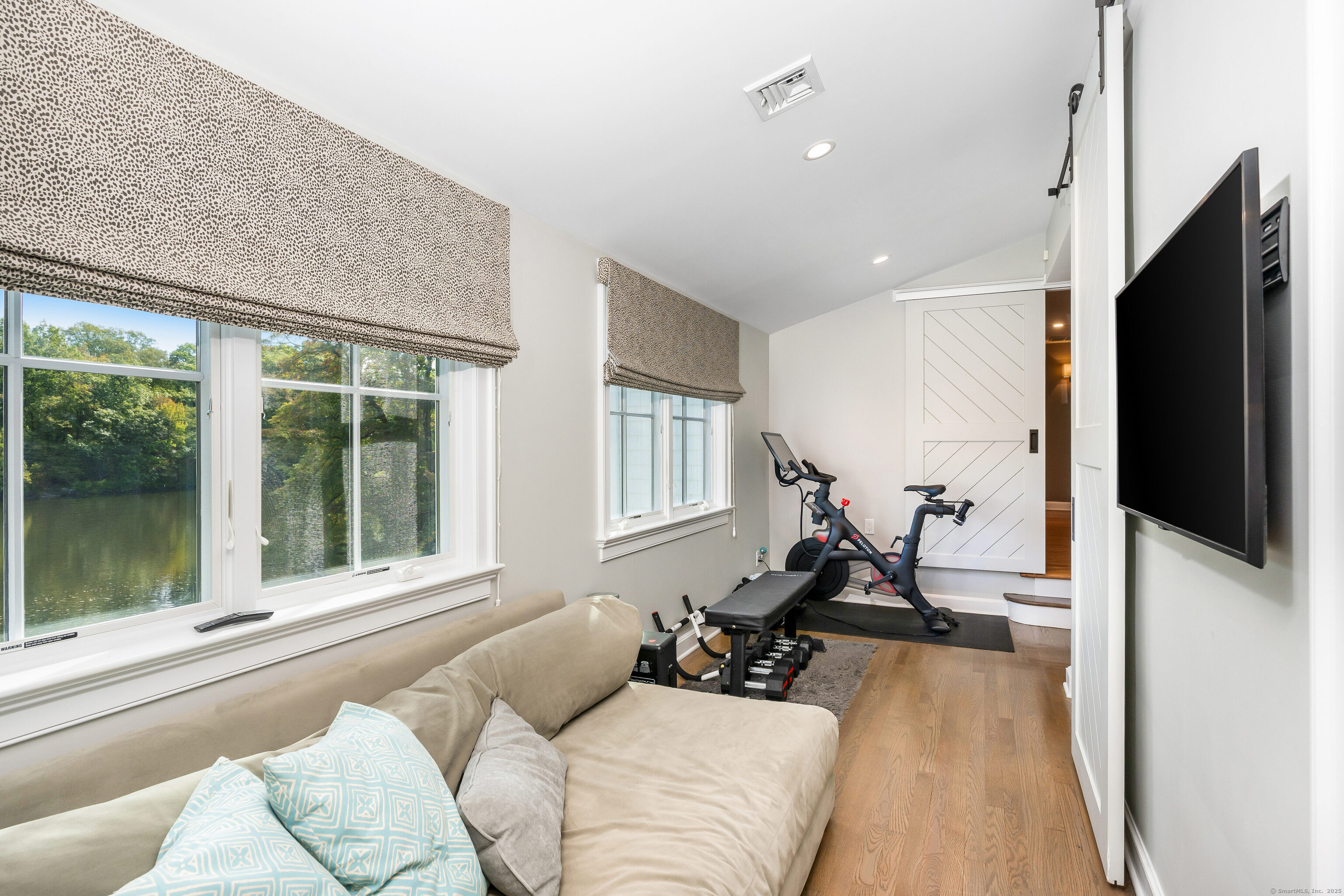 63 Dorchester Road Darien, CT 06820 - Photo 25 of 37 a living room with furniture tv and a window