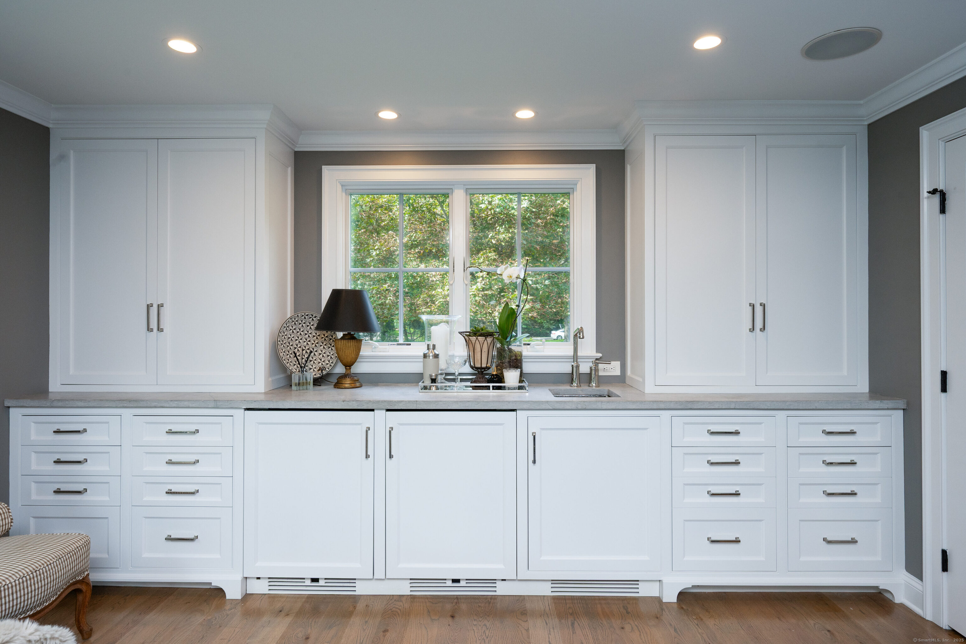 63 Dorchester Road Darien, CT 06820 - Photo 9 of 37 a kitchen with granite countertop white cabinets and sink