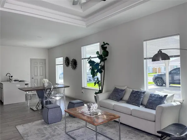 a living room with furniture and wooden floor