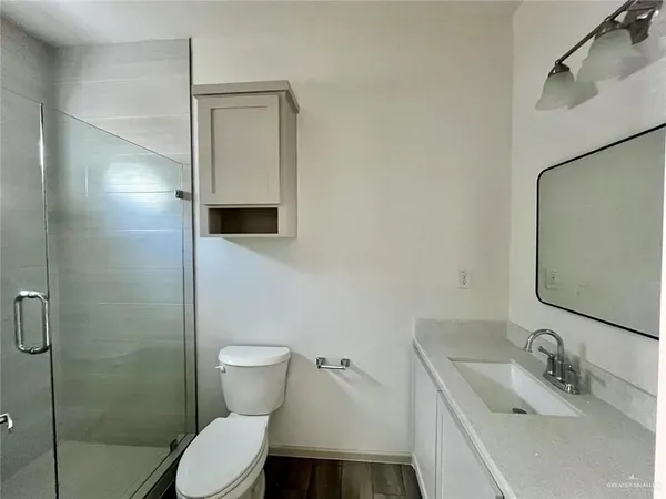 a bathroom with a toilet sink and shower
