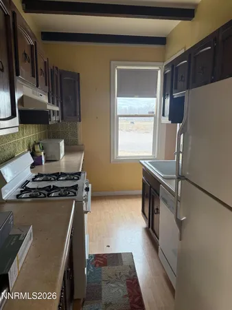 a kitchen with stainless steel appliances granite countertop a stove and a refrigerator