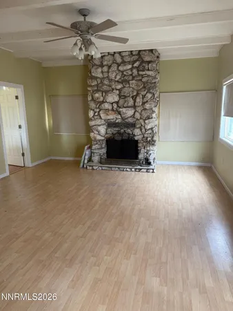 wooden floor in an empty room with a fireplace