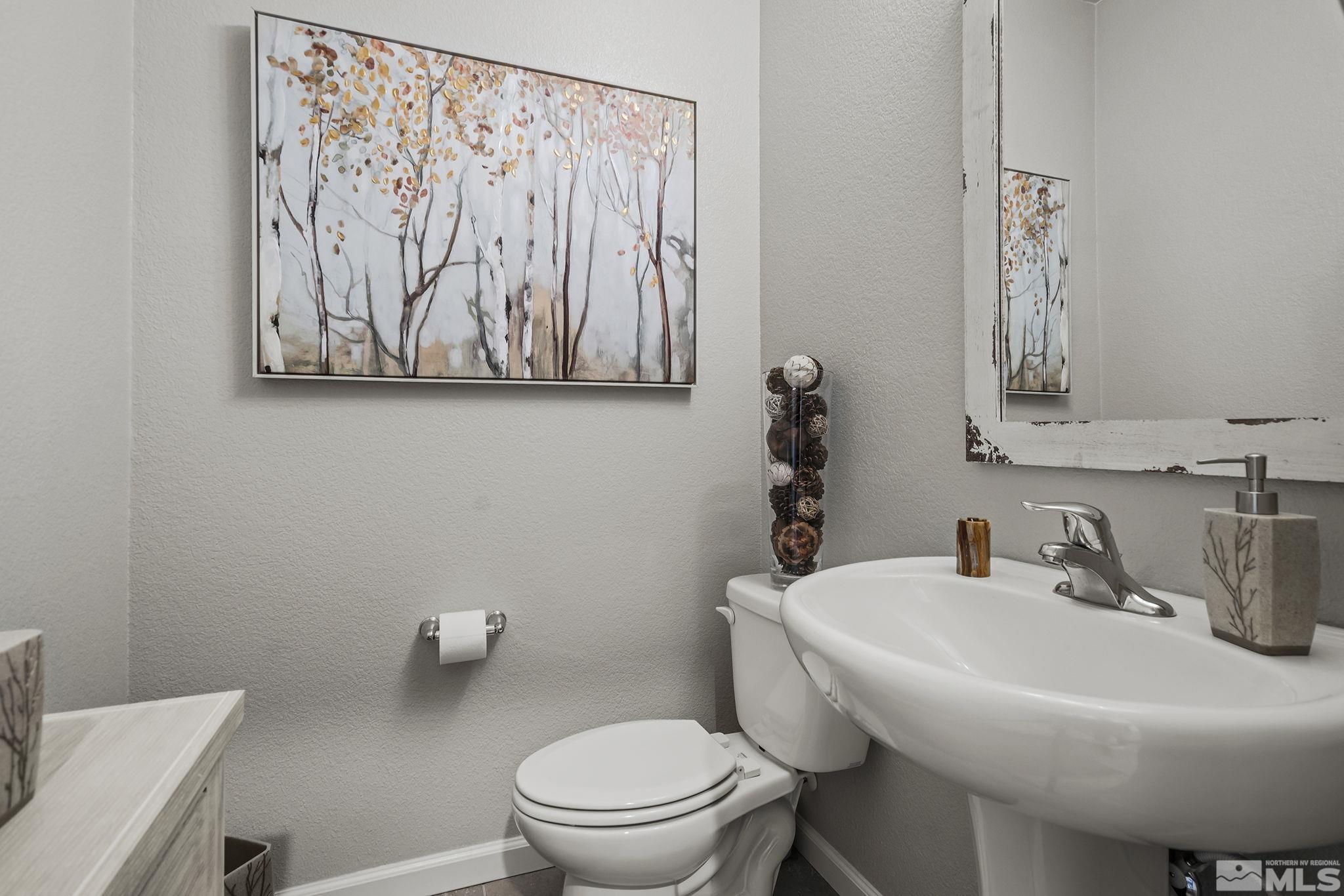 3214 Sterling Ridge Circle Sparks, NV 89431 - Photo 13 of 19 a bathroom with a toilet sink and mirror