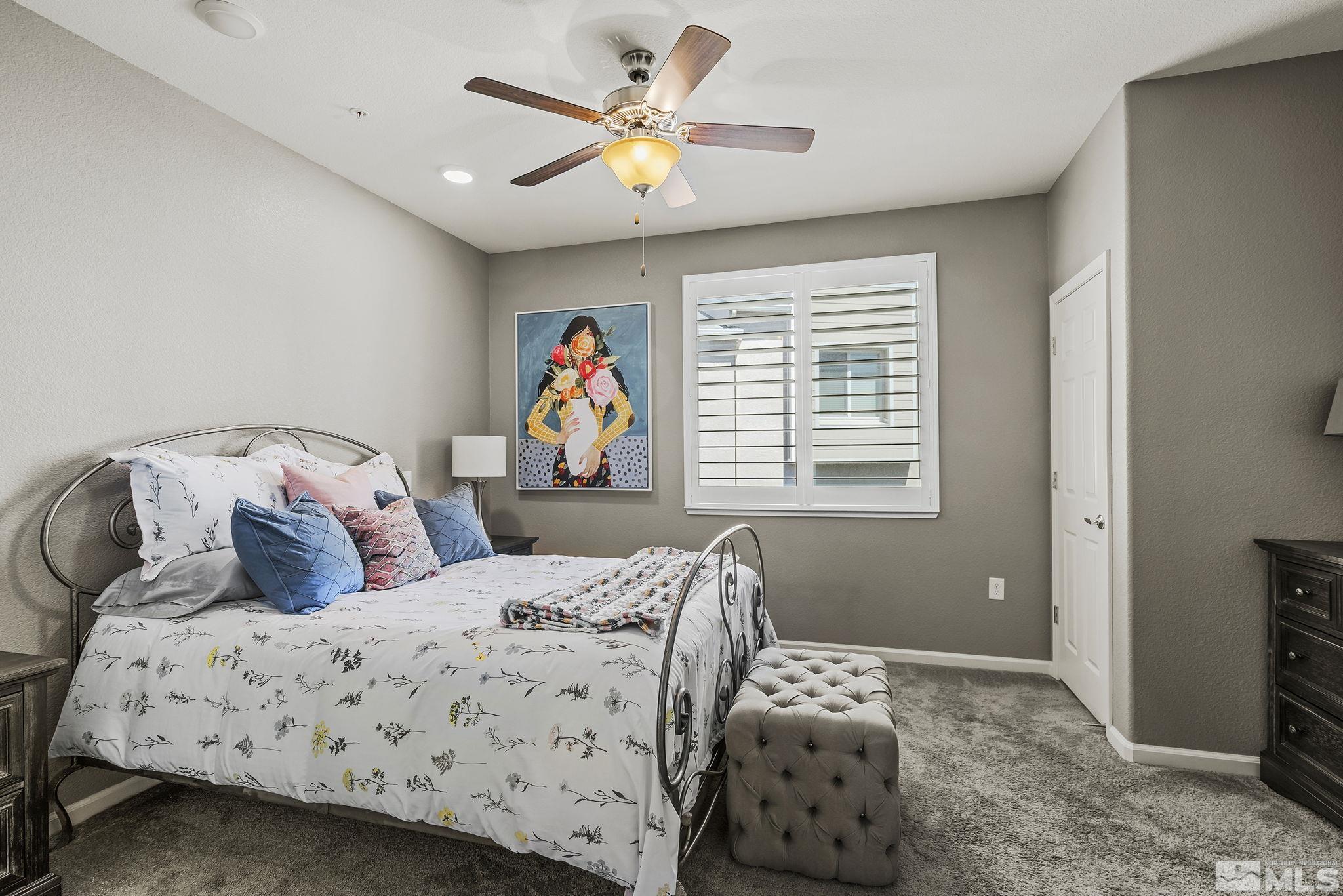 3214 Sterling Ridge Circle Sparks, NV 89431 - Photo 8 of 19 a bedroom with a bed and a chandelier