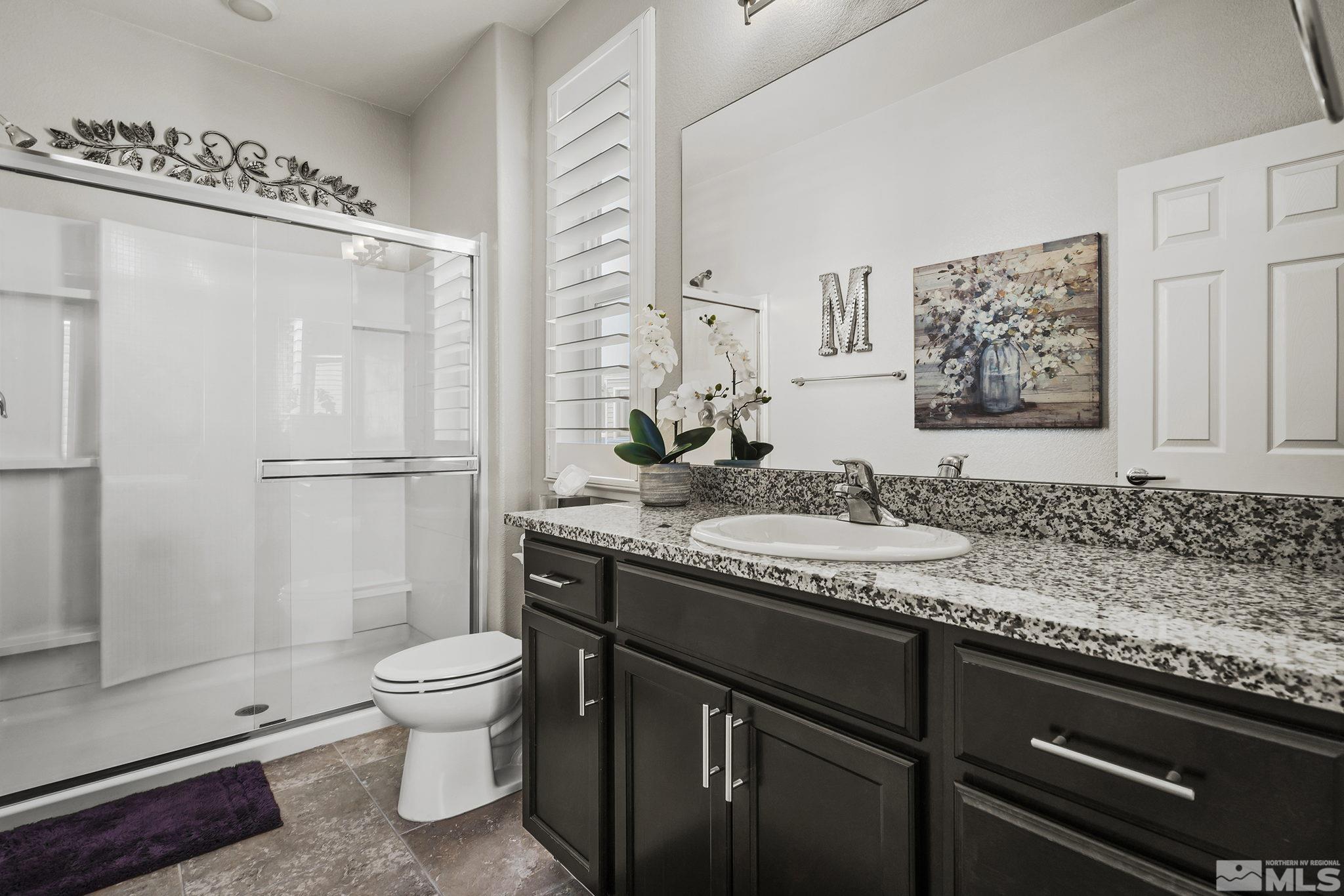 3214 Sterling Ridge Circle Sparks, NV 89431 - Photo 9 of 19 a bathroom with a granite countertop sink toilet and shower