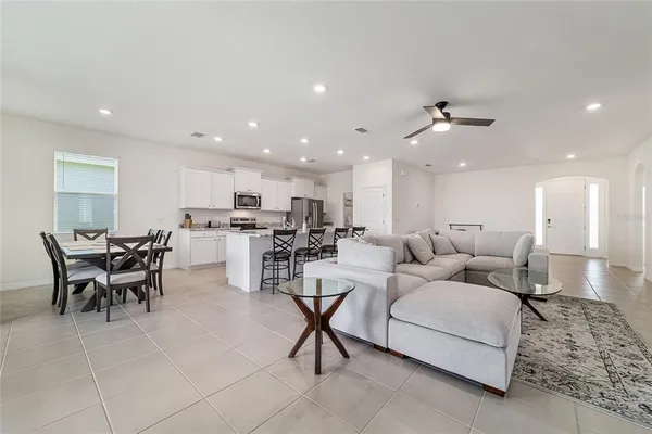 a living room with furniture and kitchen view