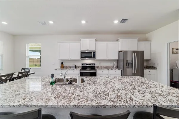 a kitchen with counter top space cabinets and stainless steel appliances