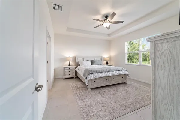 a bedroom with a large bed and a chandelier