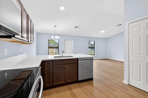 a kitchen with stainless steel appliances granite countertop a stove and a sink