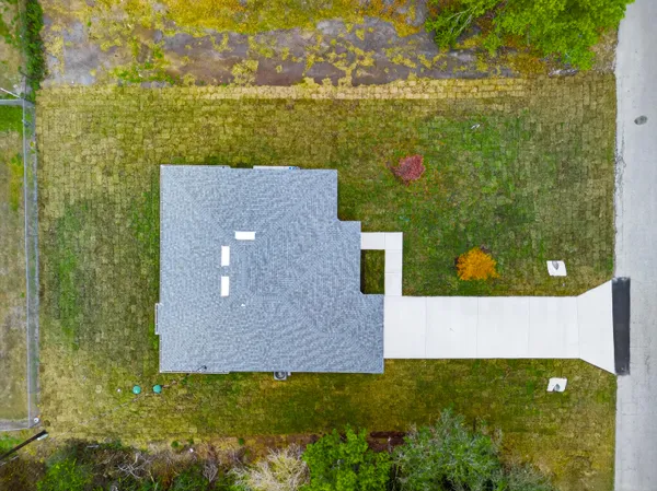 aerial view of a house with a yard