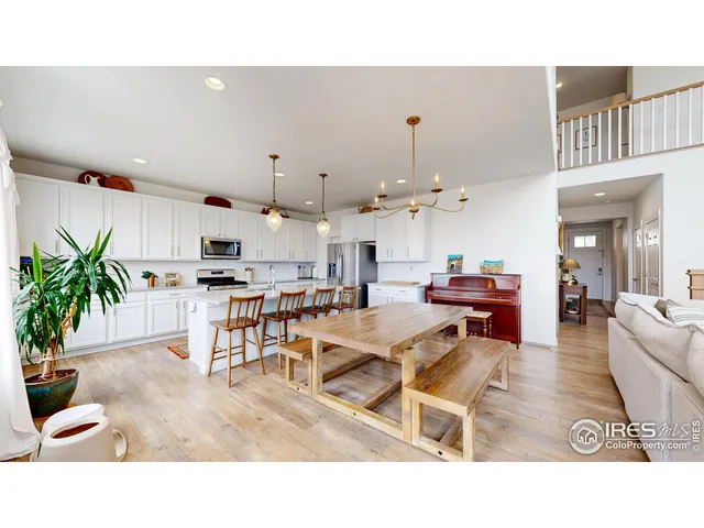 a living room with lots of furniture and kitchen view