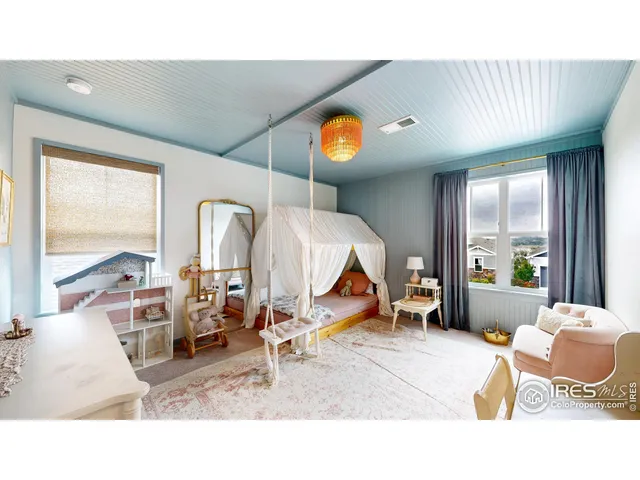 a living room with furniture and floor to ceiling window