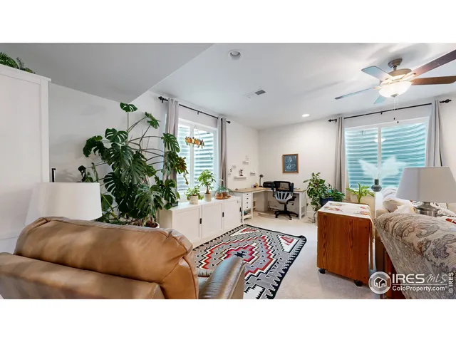 a living room with furniture potted plant and a window