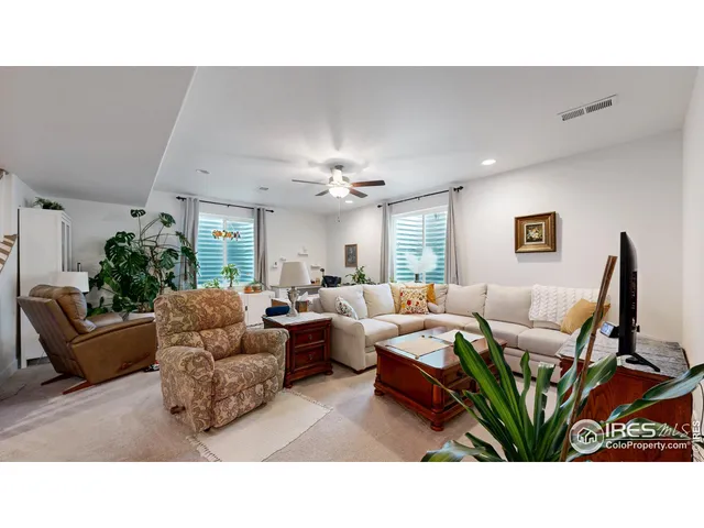 a living room with furniture potted plant and a window