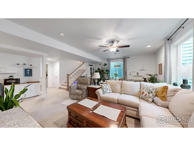 a living room with furniture and kitchen view