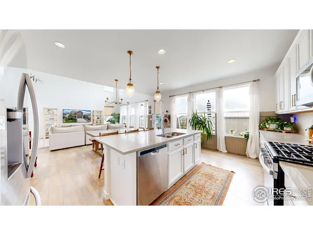 a kitchen with stainless steel appliances kitchen island granite countertop a sink and cabinets