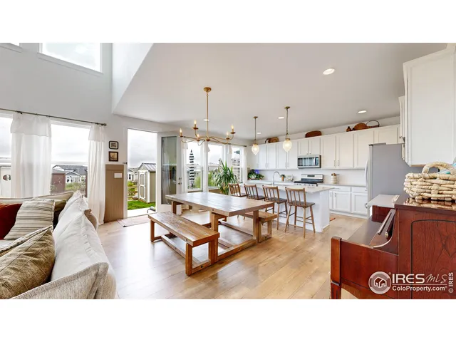 a living room with lots of furniture and kitchen view