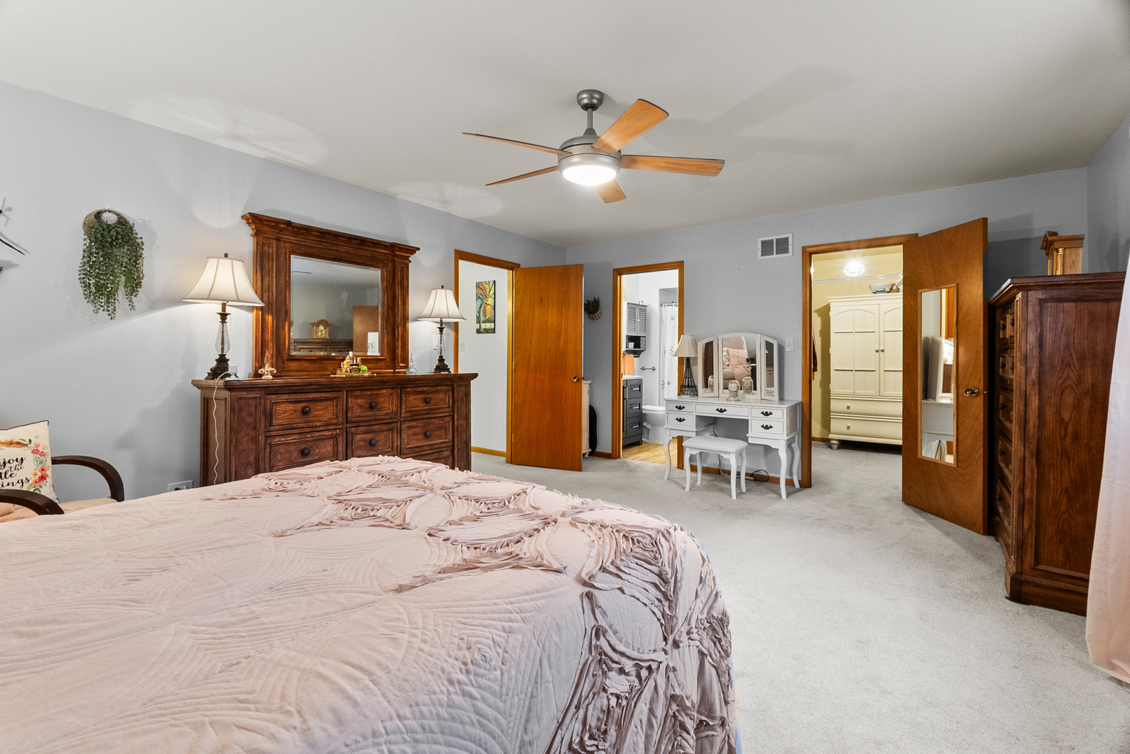 11130 Granite Drive Mokena, IL 60448 - Photo 13 of 41 a bedroom with a bed and a large mirror with a chandelier