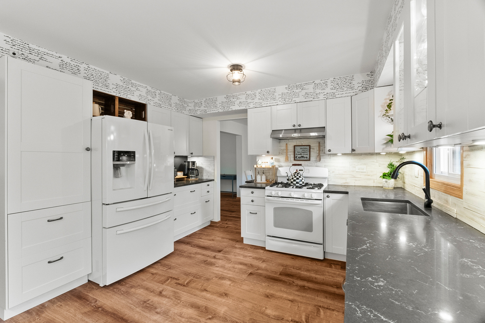 11130 Granite Drive Mokena, IL 60448 - Photo 4 of 41 a large white kitchen with stainless steel appliances granite countertop a stove a sink dishwasher and white cabinets with wooden floor