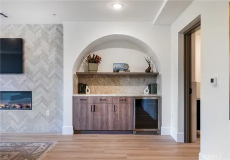 a living room with a fireplace and a wooden floor
