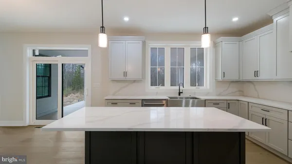 a view of a kitchen with a sink and a fireplace
