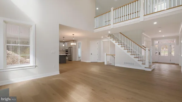 a view of an entryway with wooden floor and windows