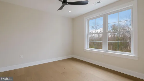 a view of a room with wooden floor and window