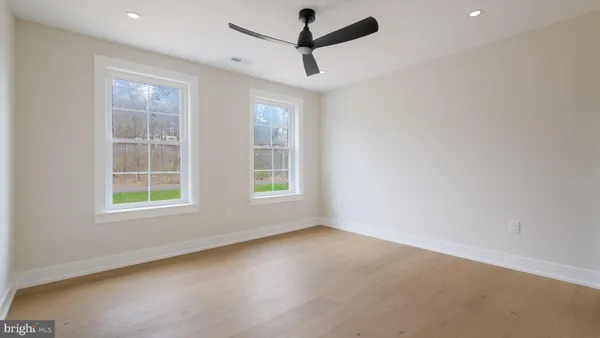 a view of an empty room with a kitchen