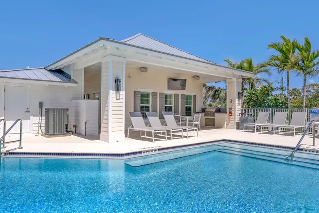 a view of swimming pool with a garden and outdoor seating