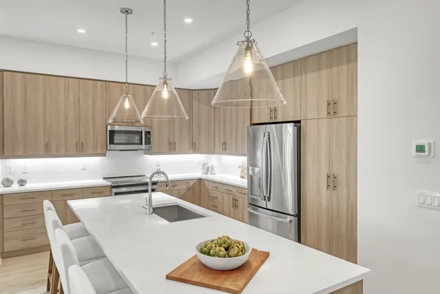 a kitchen with kitchen island a table and chairs