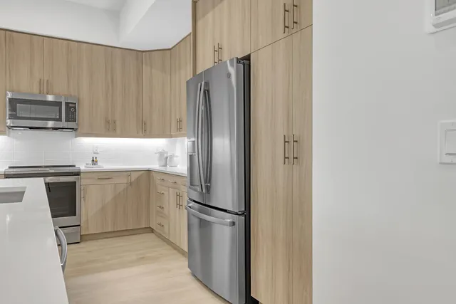 a view of a dining room with furniture large windows and wooden floor