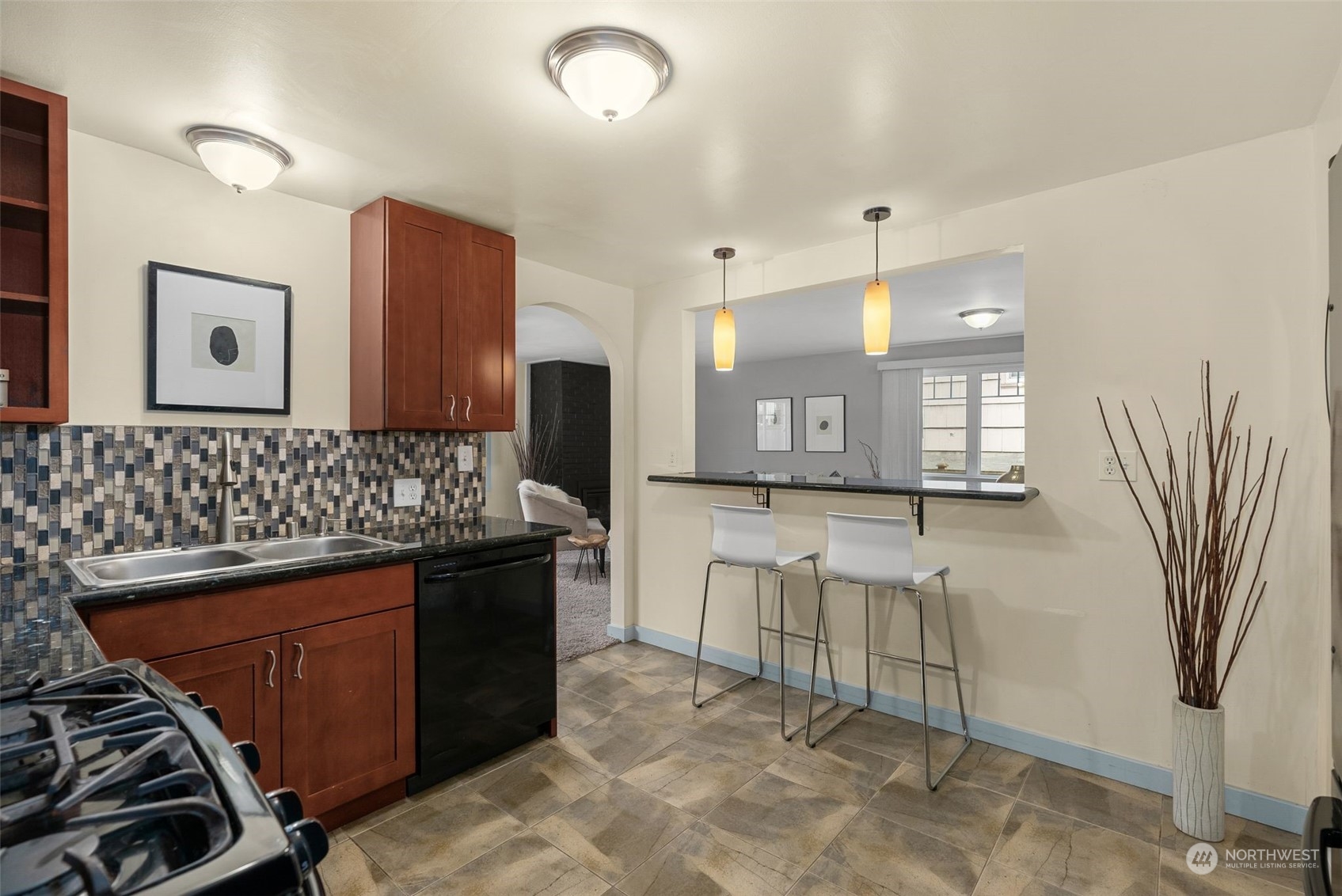 5915 Southwest Admiral Way Seattle, WA 98116 - Photo 13 of 31 a kitchen with stainless steel appliances granite countertop a sink stove and cabinets