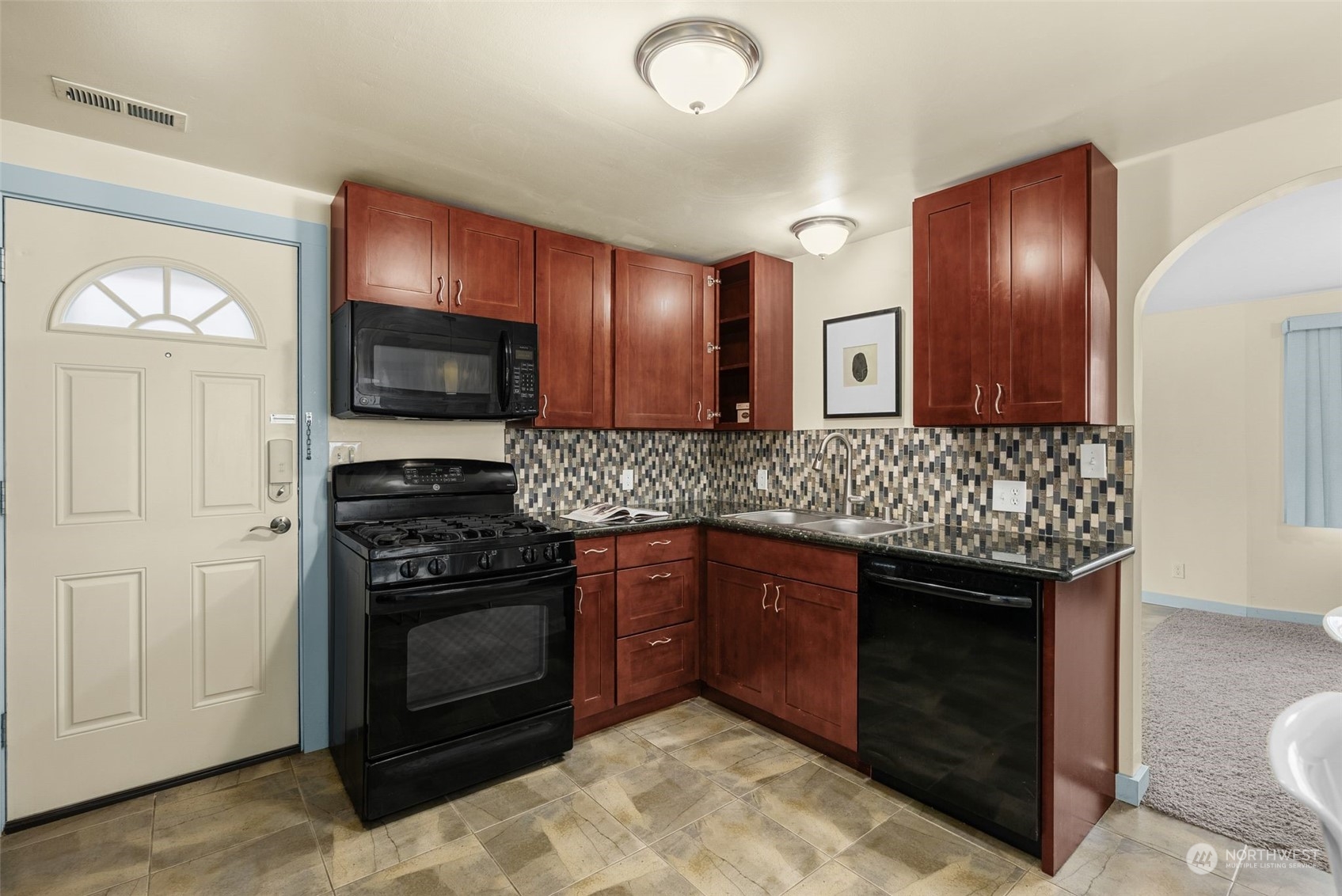 5915 Southwest Admiral Way Seattle, WA 98116 - Photo 14 of 31 a kitchen with stainless steel appliances granite countertop a stove and a sink