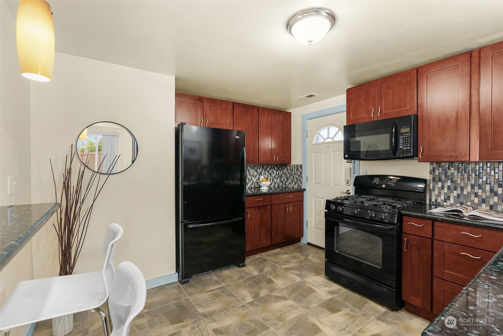 5915 Southwest Admiral Way Seattle, WA 98116 - Photo 16 of 31 a kitchen with stainless steel appliances granite countertop a refrigerator stove top oven a sink and dishwasher