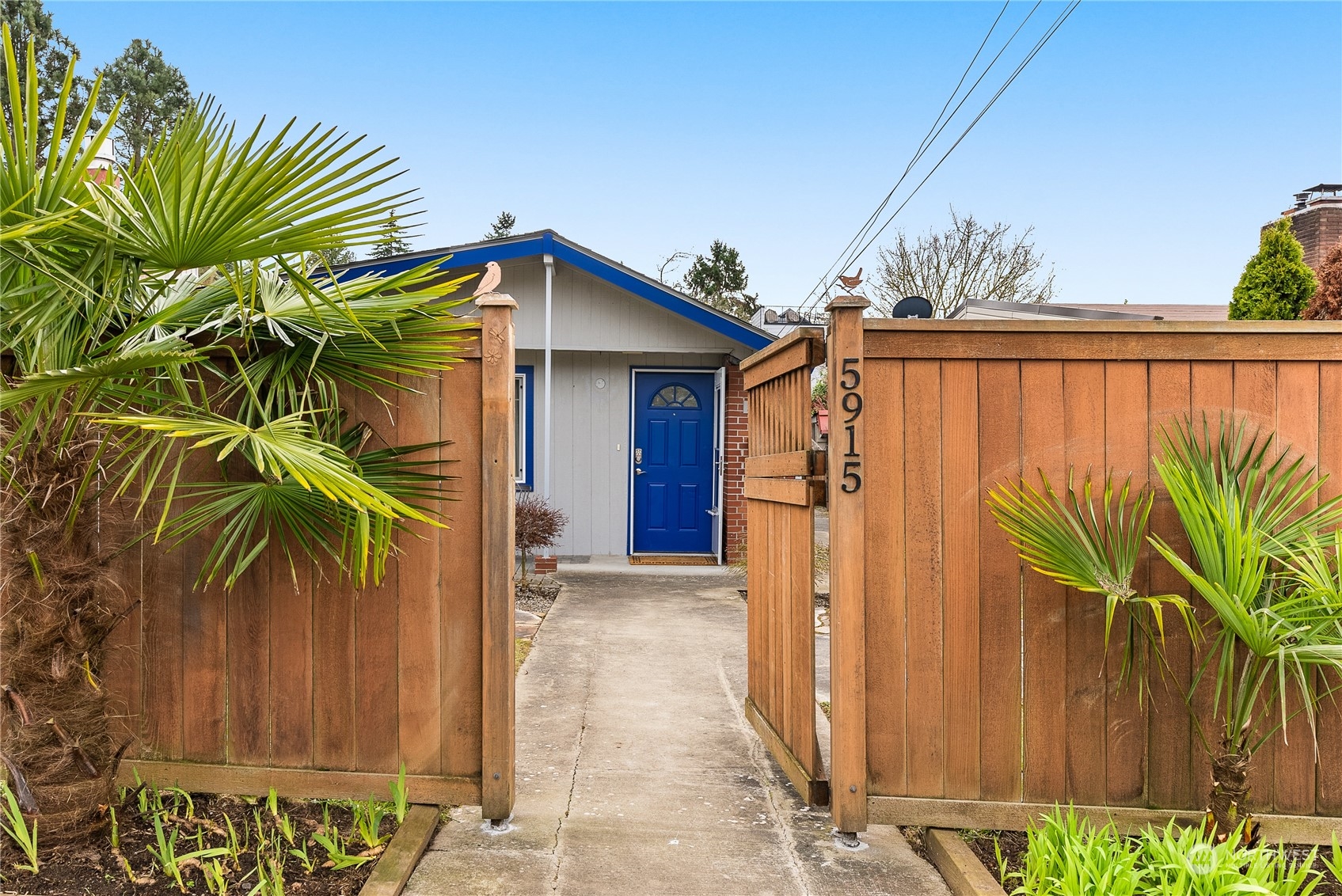 5915 Southwest Admiral Way Seattle, WA 98116 - Photo 2 of 31 a view of a house with a small yard and plants