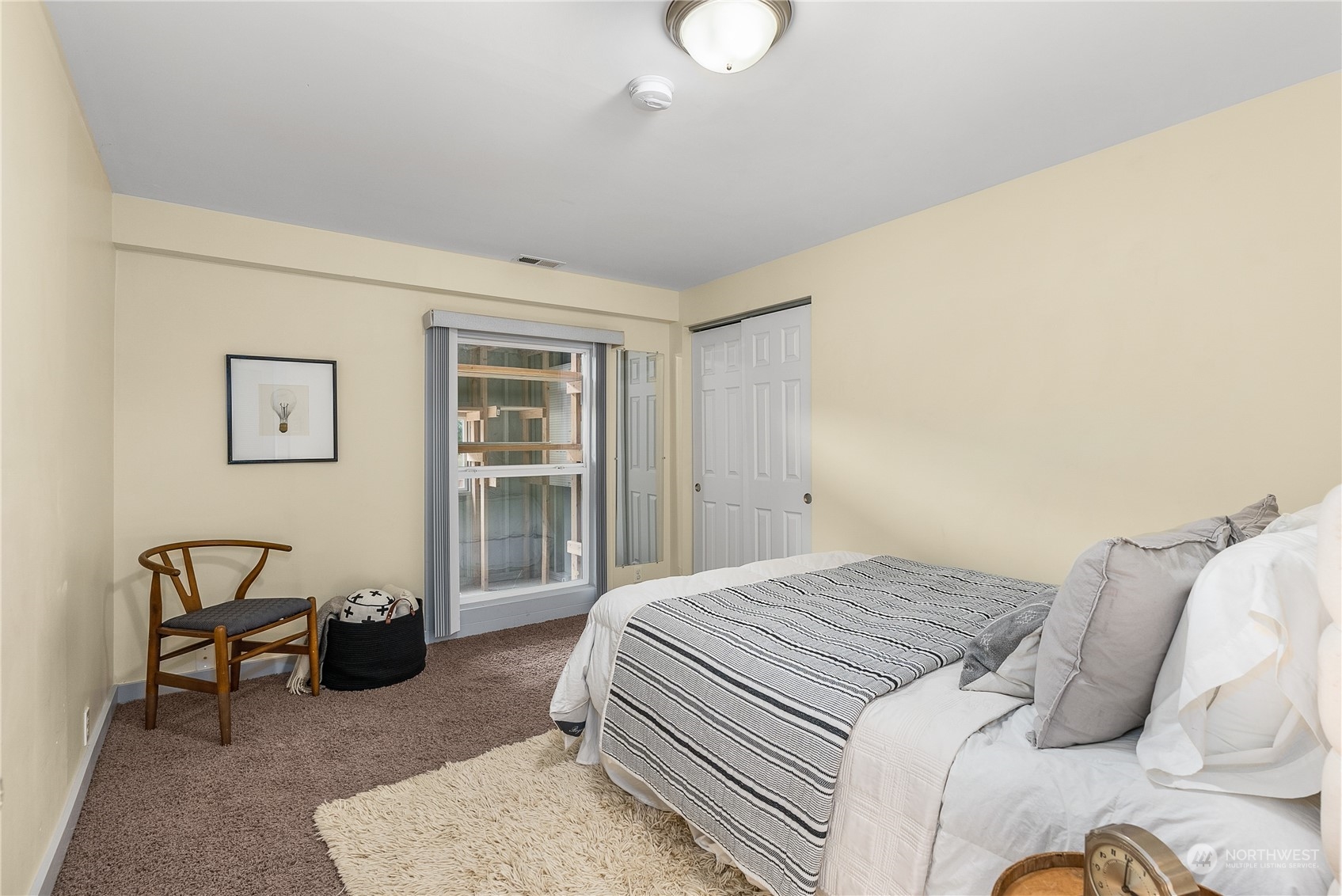 5915 Southwest Admiral Way Seattle, WA 98116 - Photo 21 of 31 a bedroom with a bed a table and chair