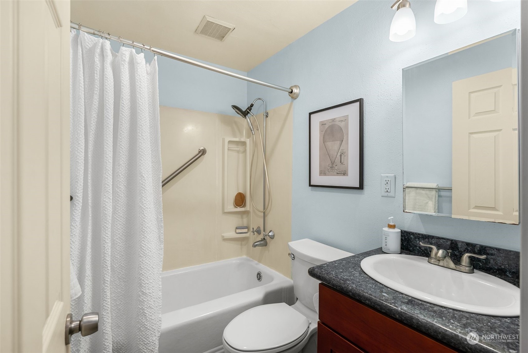 5915 Southwest Admiral Way Seattle, WA 98116 - Photo 22 of 31 a bathroom with a granite countertop sink toilet bathtub and shower
