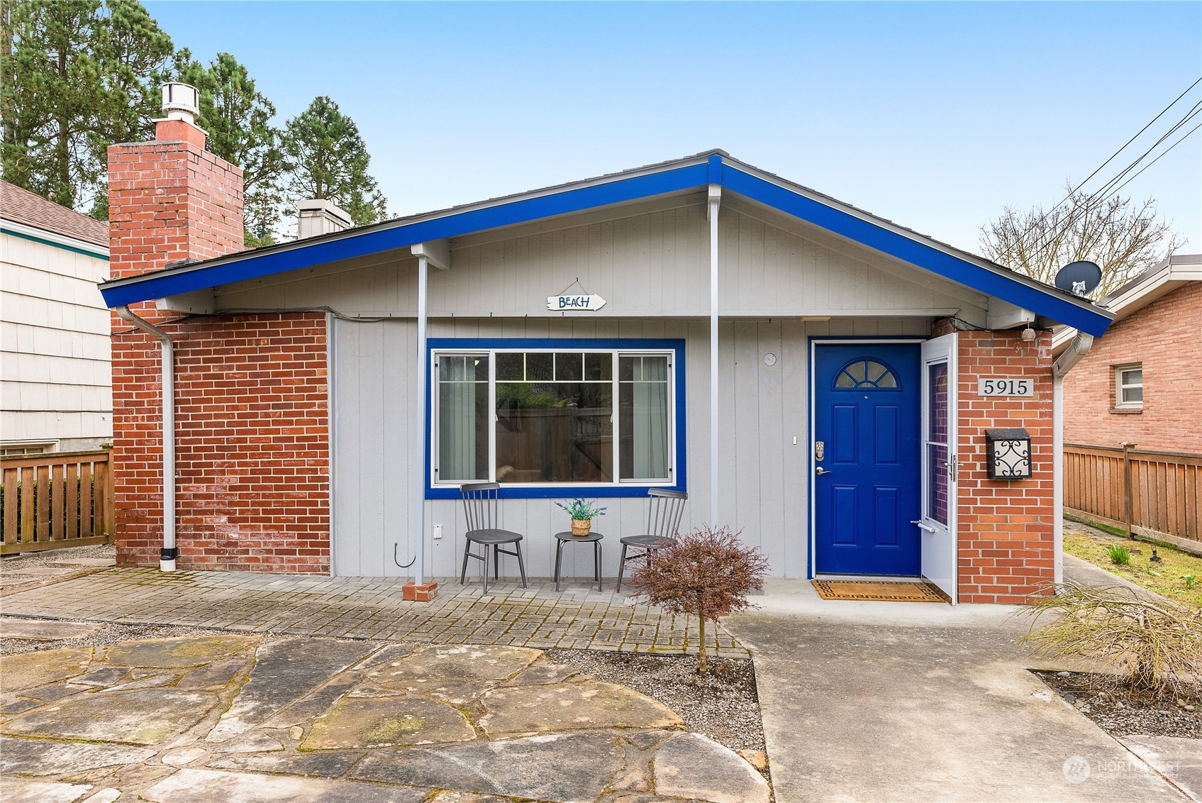 5915 Southwest Admiral Way Seattle, WA 98116 - Photo 3 of 31 a front view of a house with a yard