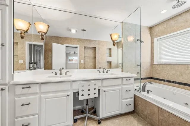 a bathroom with a sink a toilet and a large mirror