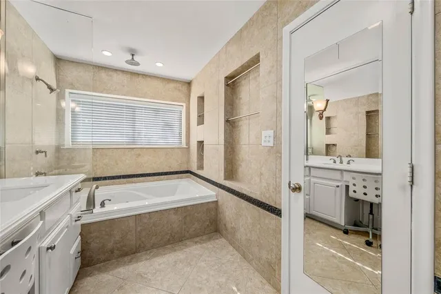 an empty room with windows and ceiling fan