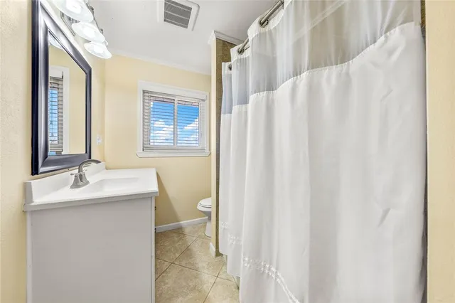 an empty room with a ceiling fan and a window