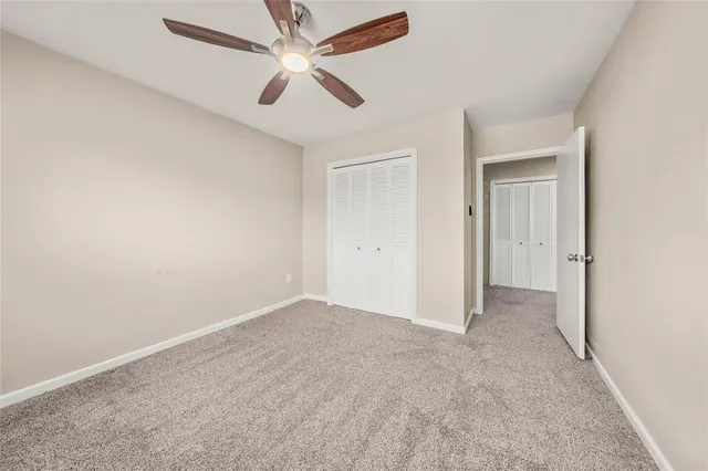 a view of a livingroom with a ceiling fan and window