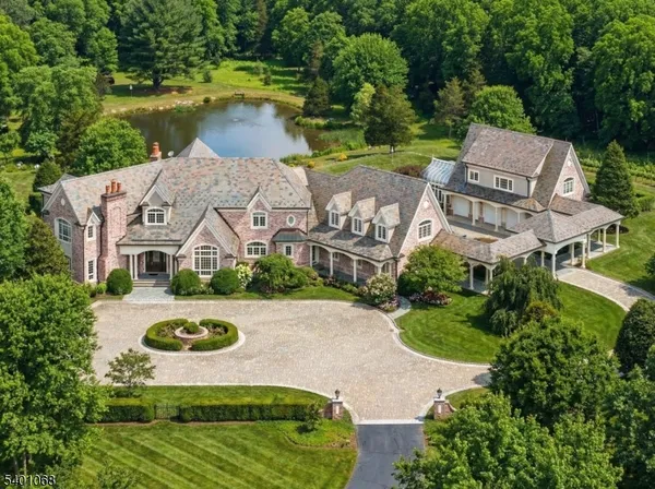 an aerial view of a house with garden space and a lake view