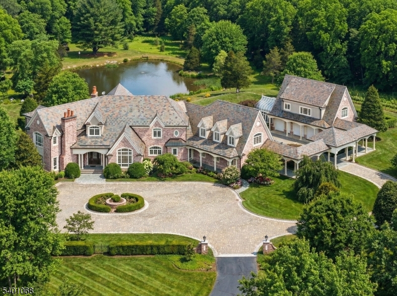 an aerial view of a house with garden space and a lake view